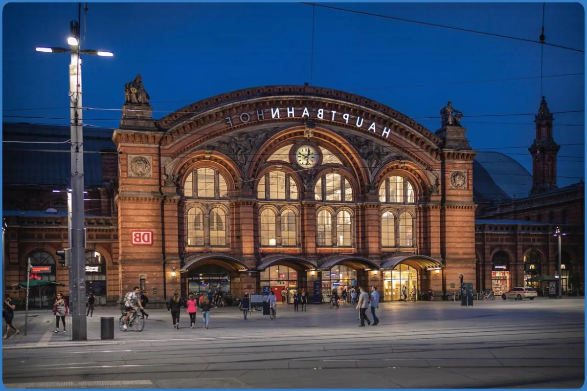 Hauptbahnhof bei Nacht mit Menschen davor