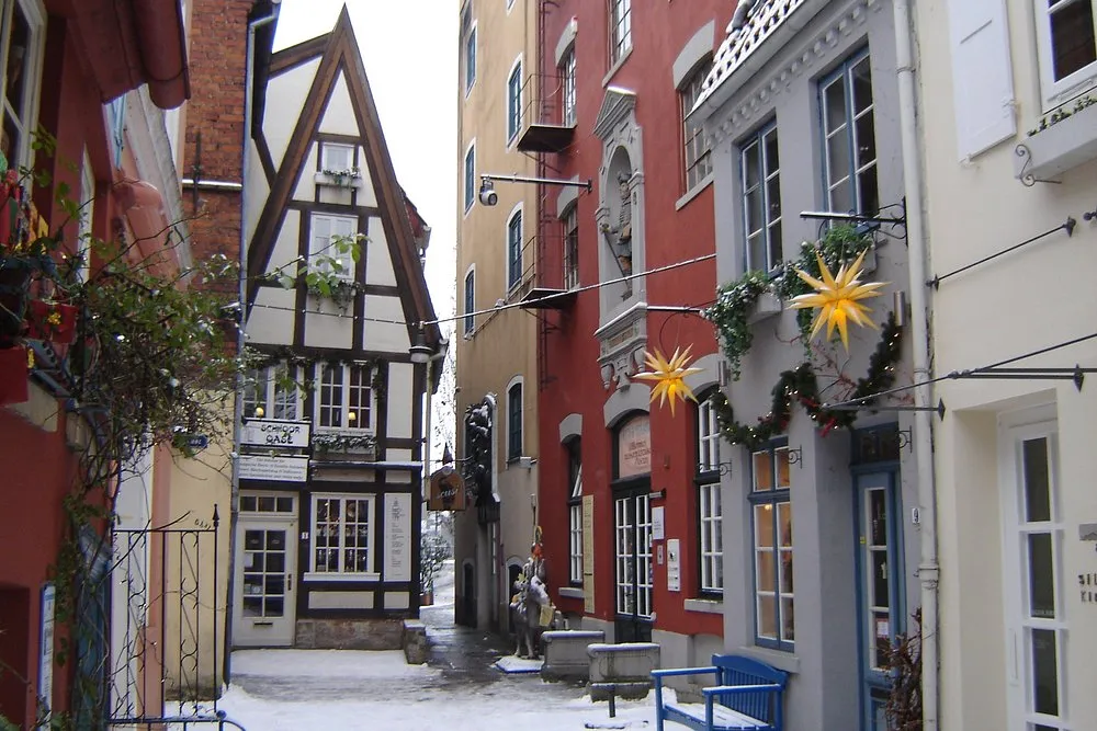Verschneite Gasse mit Fachwerkhaus und Dekorationen