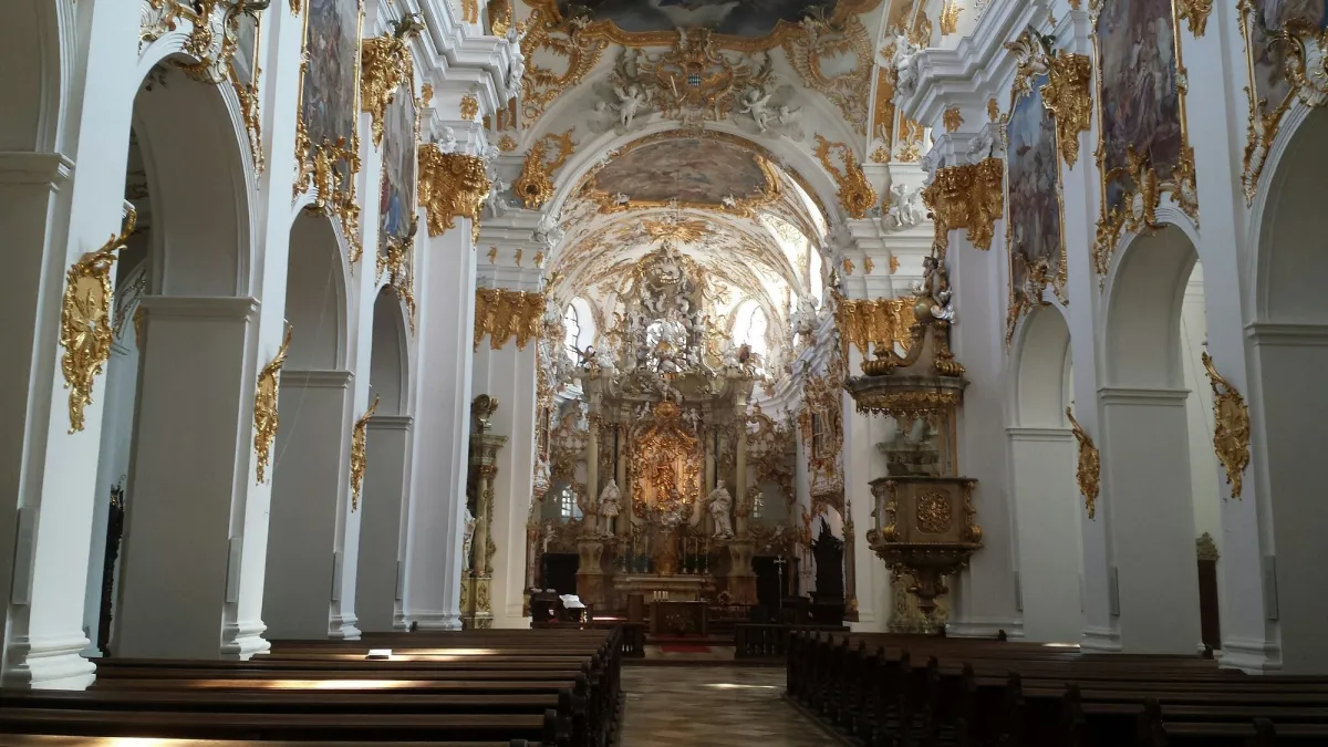 Innenansicht einer barocken Kirche mit reich verzierten Wänden.
