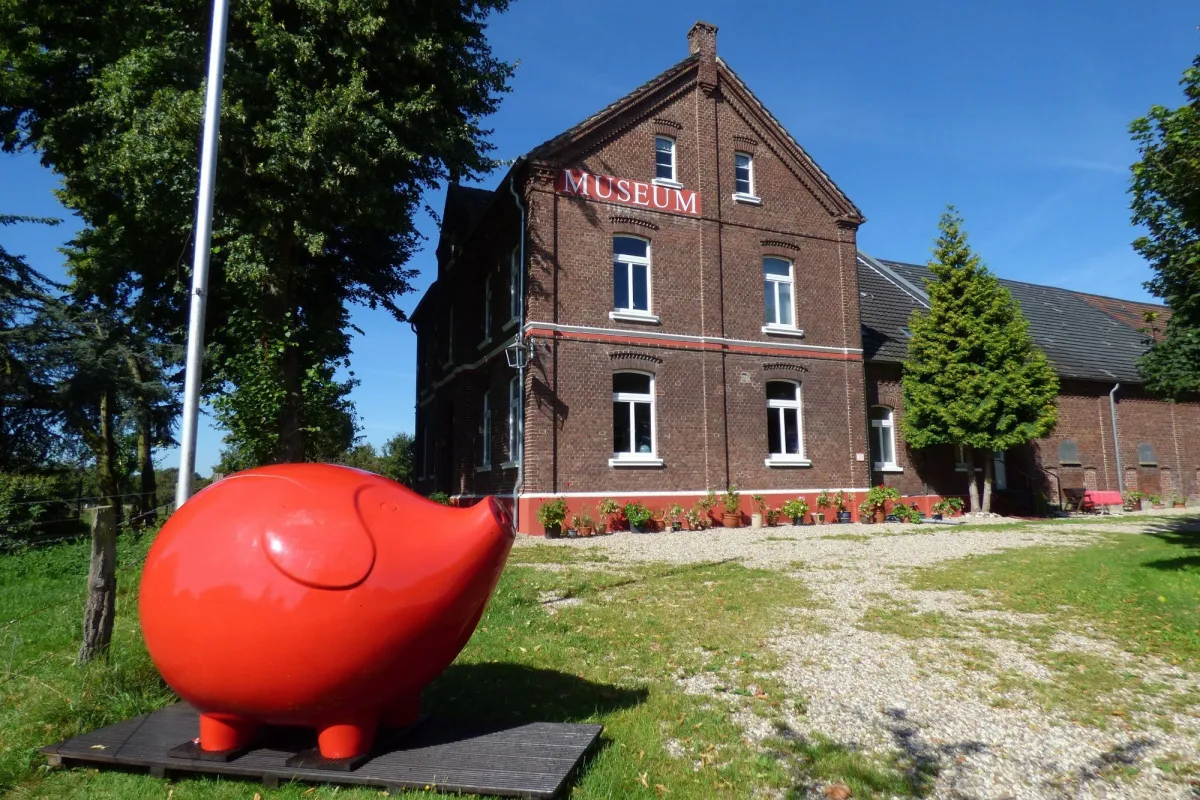 Rotes Schwein vor einem Backsteinmuseum