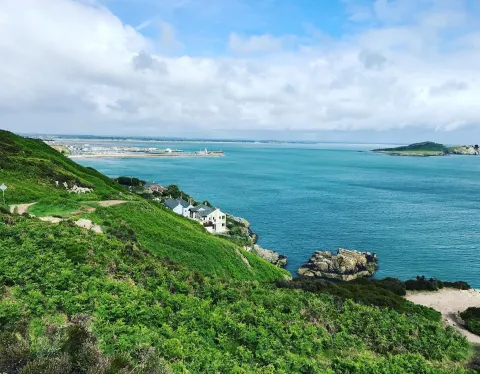 Coastal landscape with green hills and blue sea