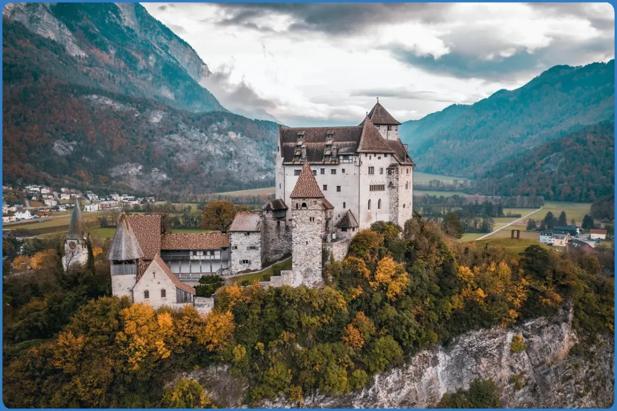 Castle on a hill surrounded by autumn trees.