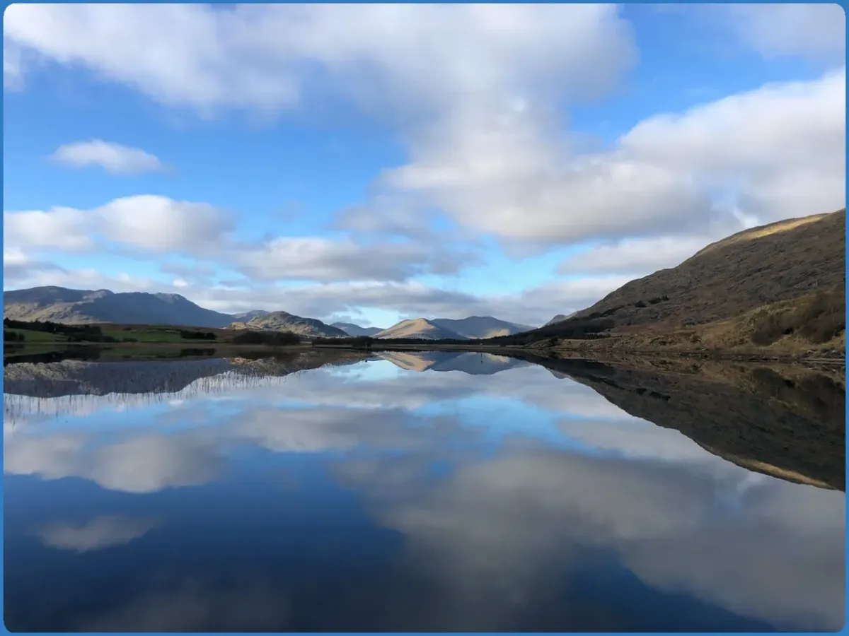 Mountain landscape reflected in a calm lake.