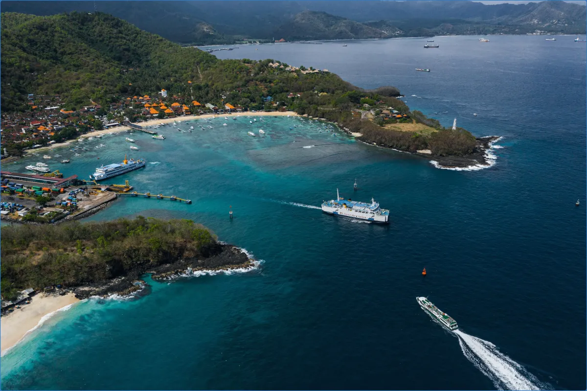 Aerial view of a coastal town with ferries in the water.