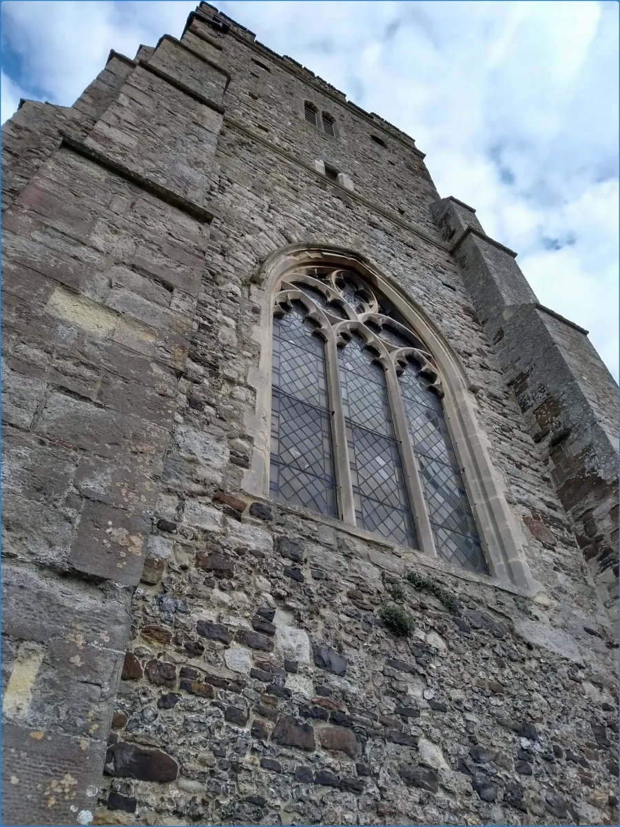 Stone church tower with arched window