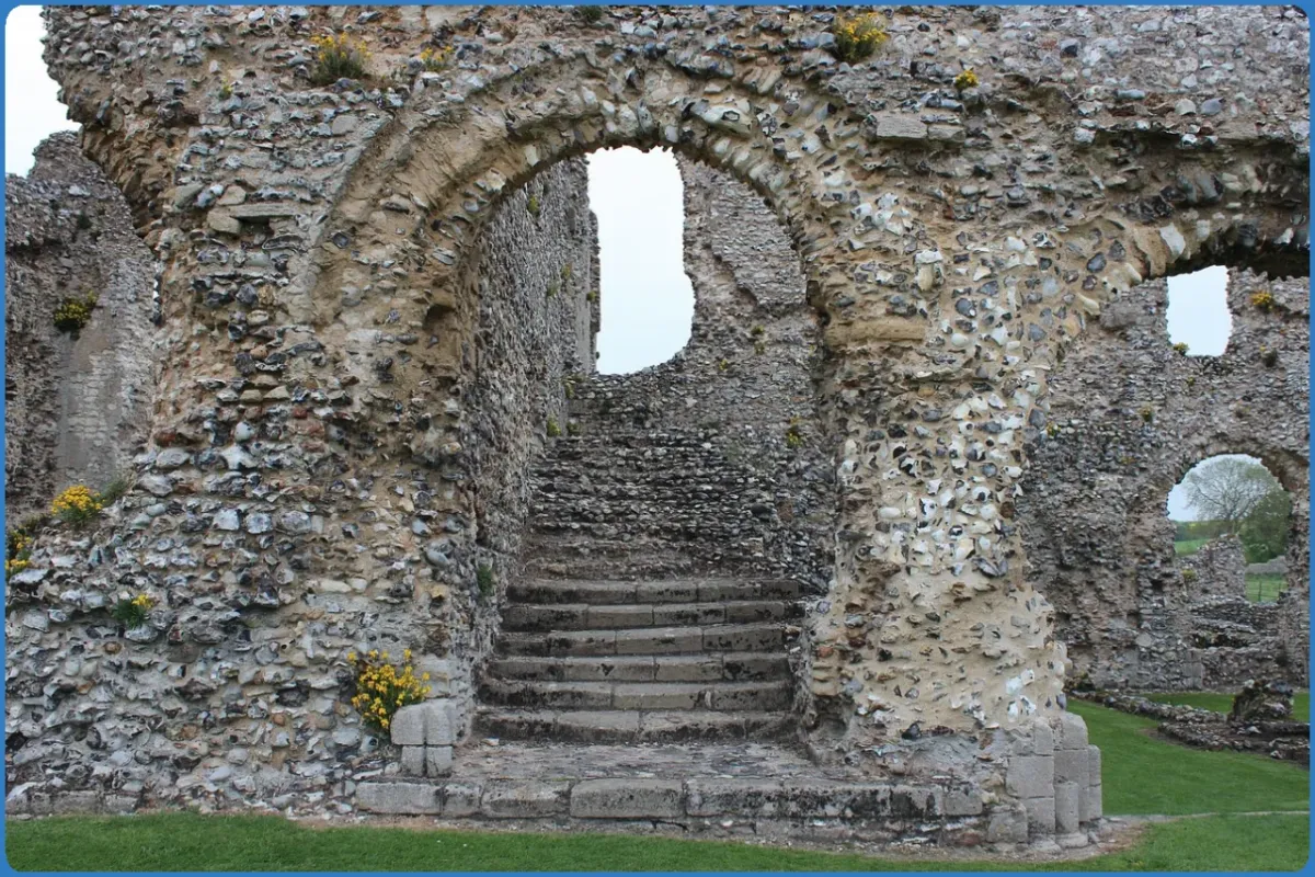 Stone archway and steps in ancient ruins.