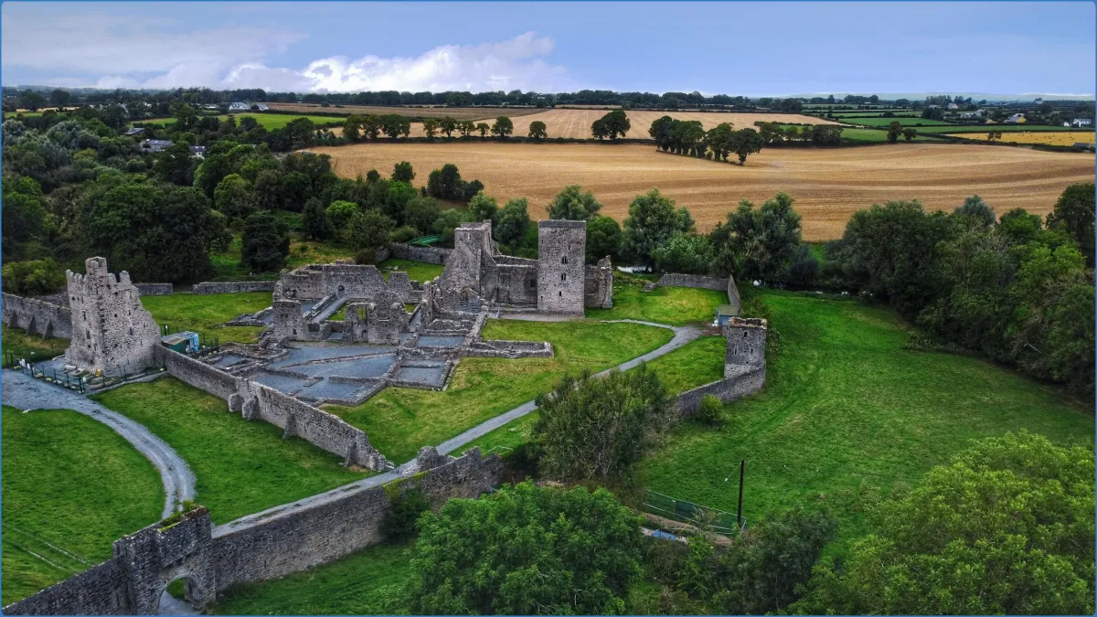 Aerial view of a medieval castle ruin in a rural landscape.