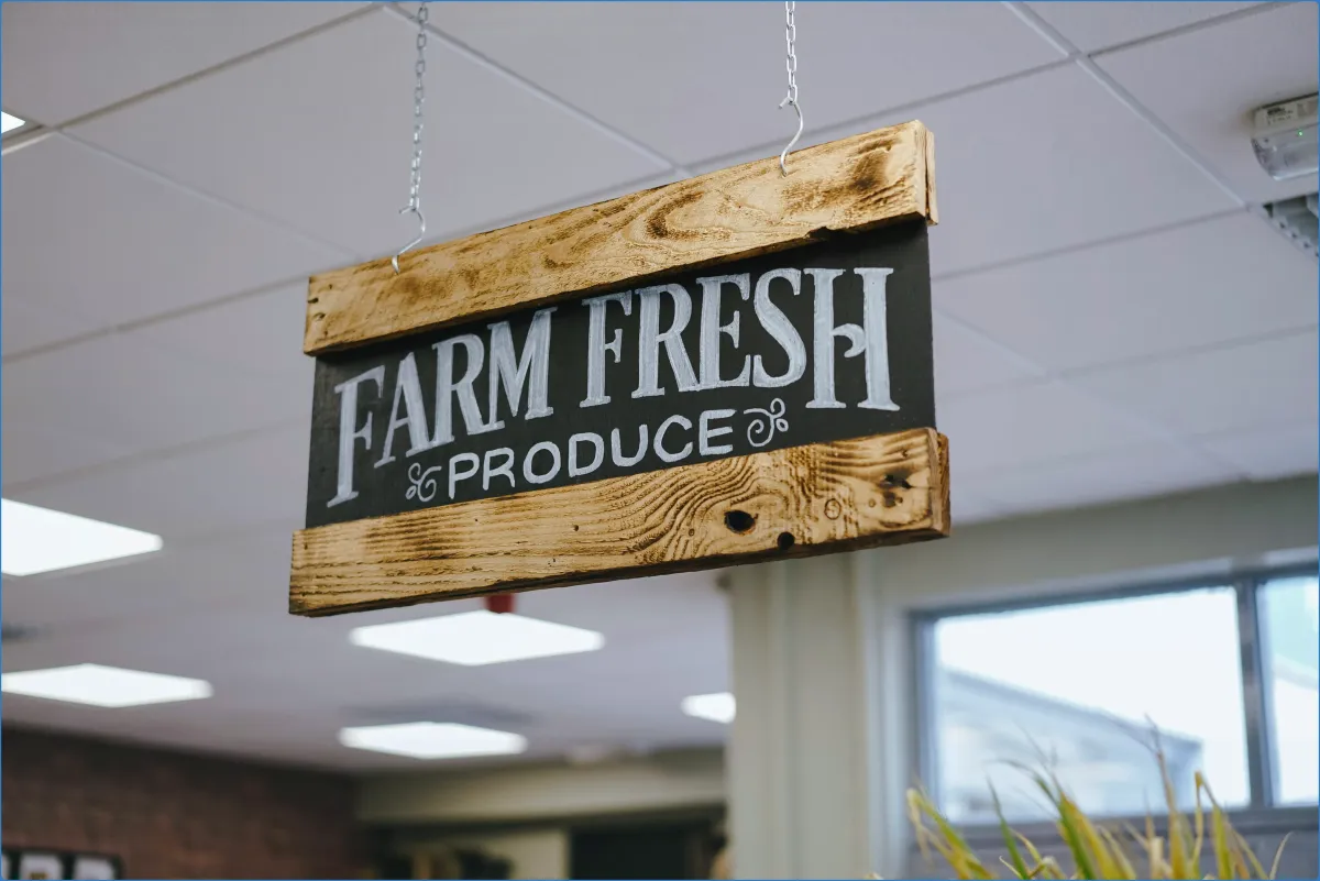 Hanging sign reading 'Farm Fresh Produce'