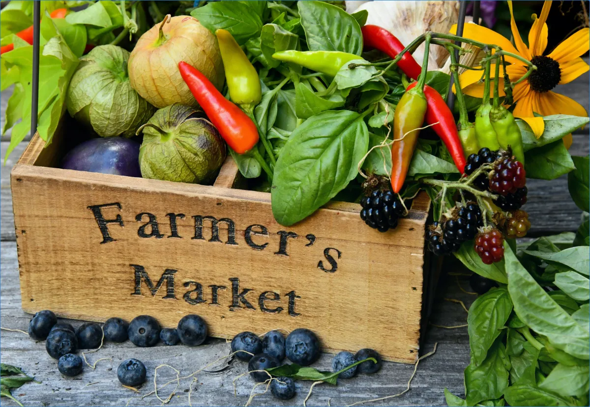 Wooden box labeled Farmer's Market with fresh produce