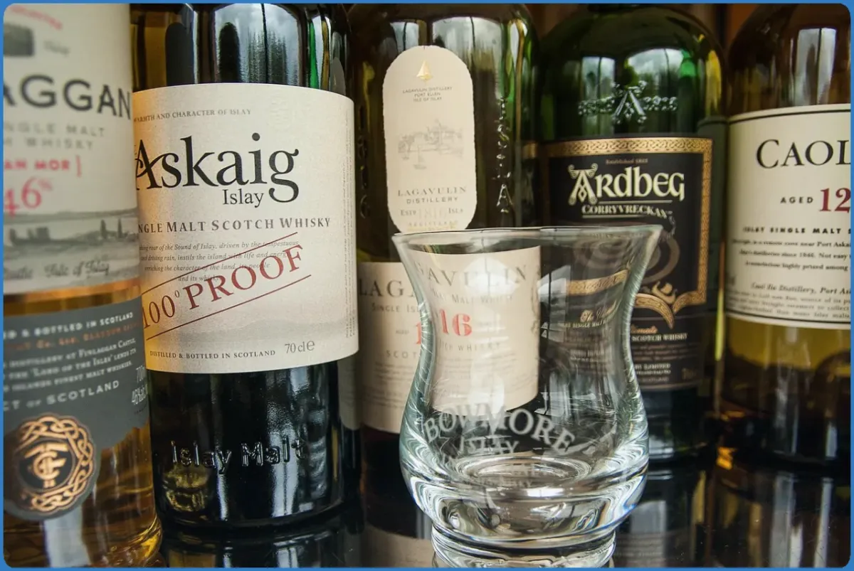 Bottles of Islay single malt whisky with a glass.