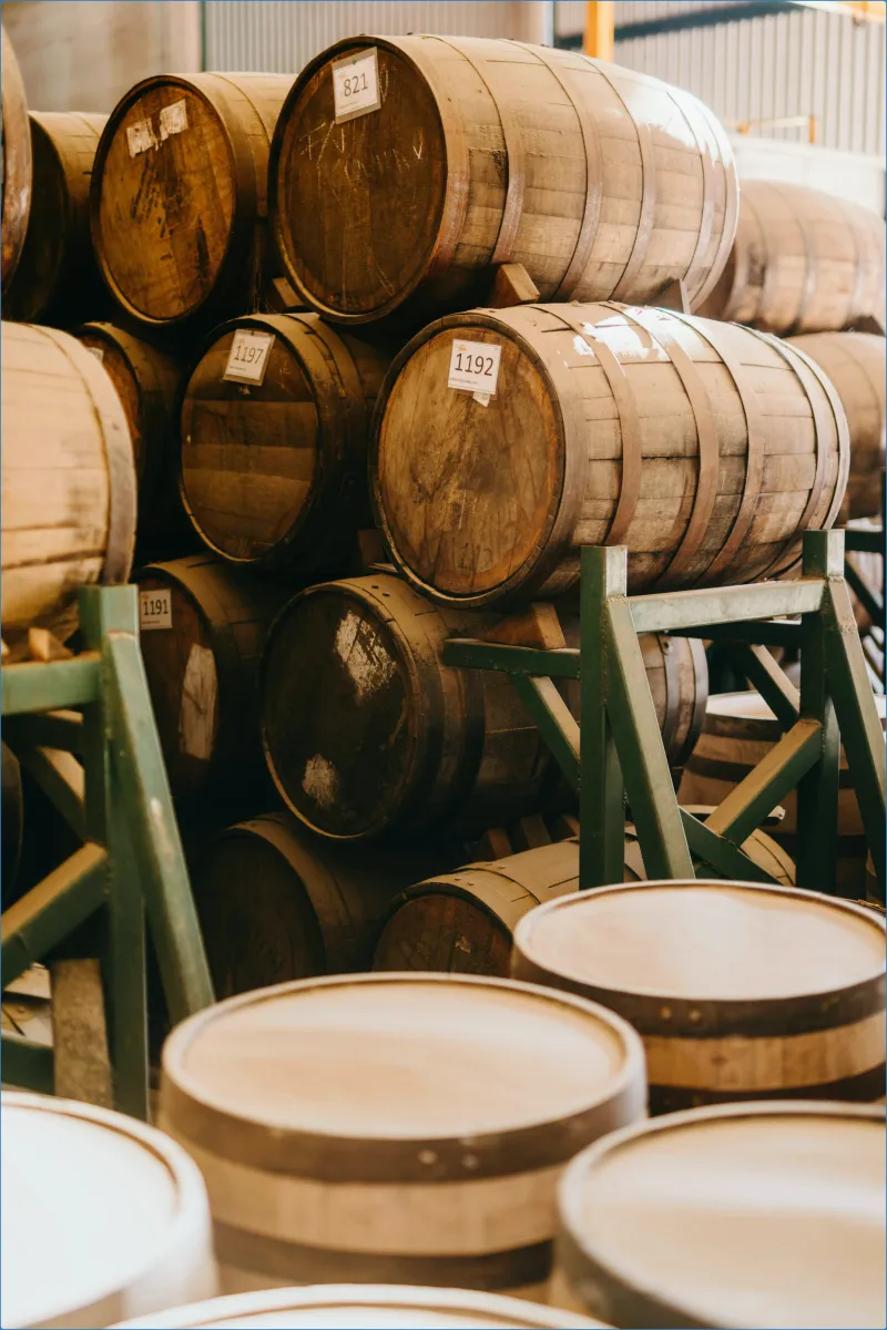 Stacked wooden barrels in a warehouse