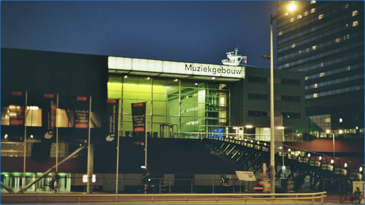 Exterior view of Muziekgebouw at night.