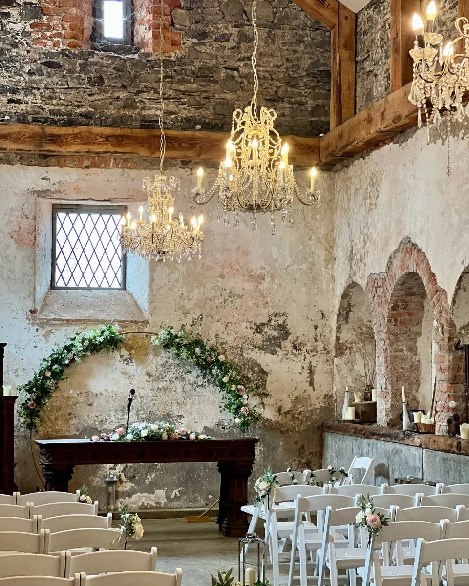 Rustic wedding venue with floral decorations.