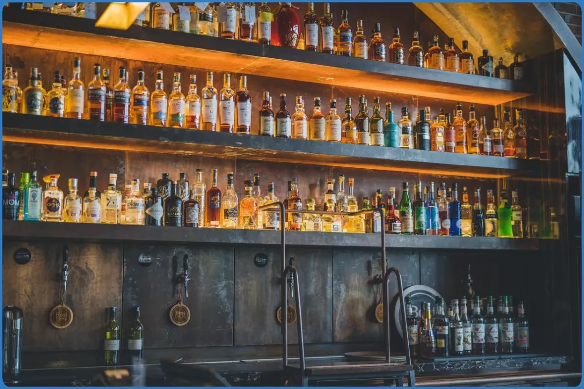 Bar shelves filled with various liquor bottles.