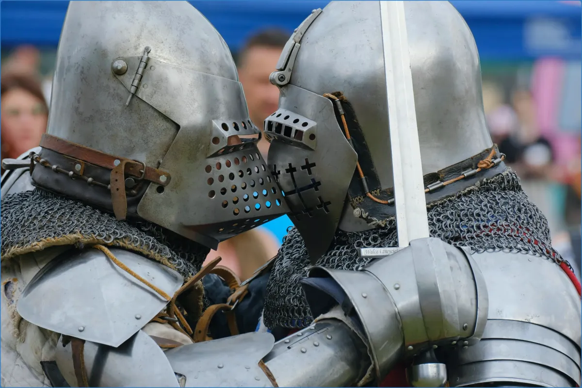 Two knights in armor facing each other closely.
