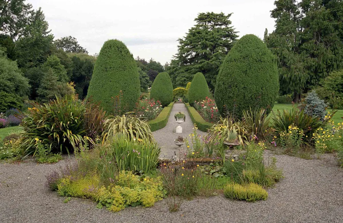 Symmetrical garden with trimmed hedges and flowers