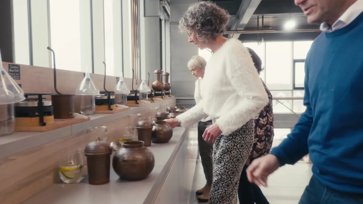 People examining jars on a counter