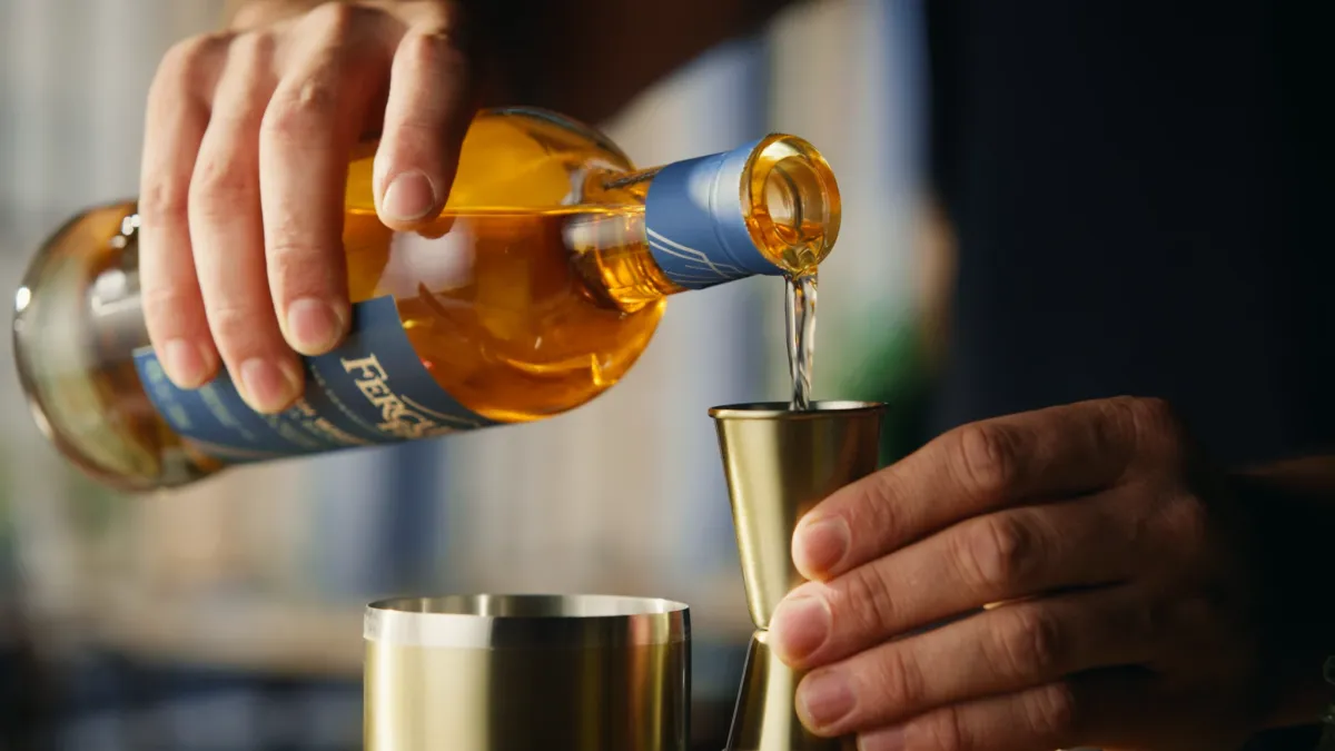 Pouring liquid into a jigger