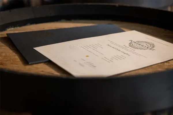 Certificate and envelope on a wooden surface.
