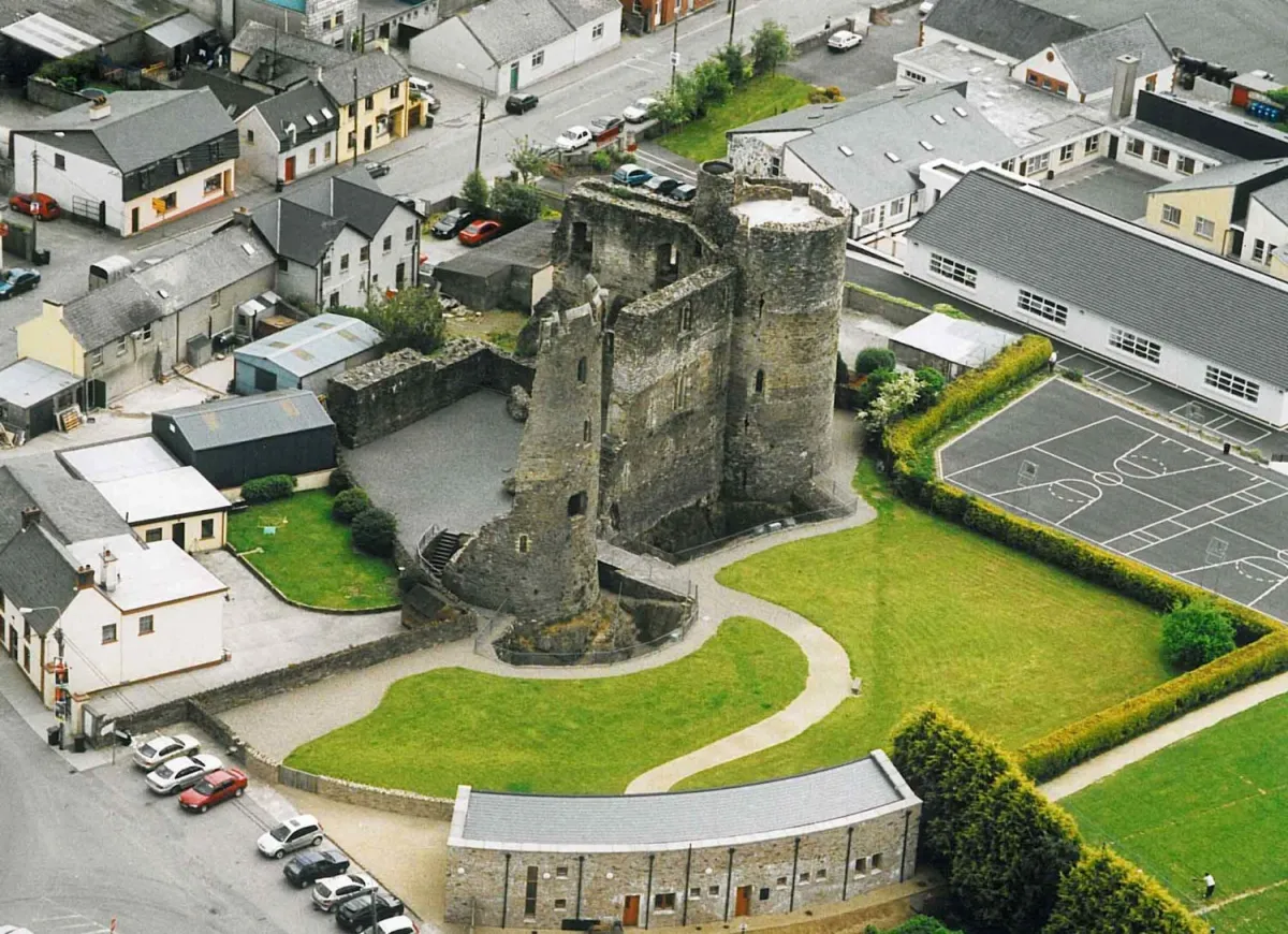 Aerial view of a historic stone castle surrounded by buildings.