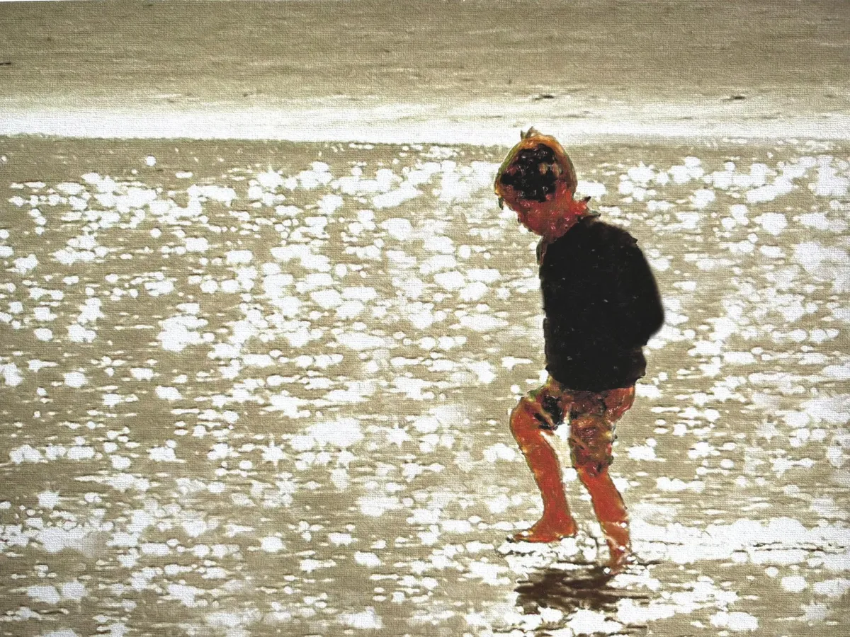 Child walking on a sandy beach