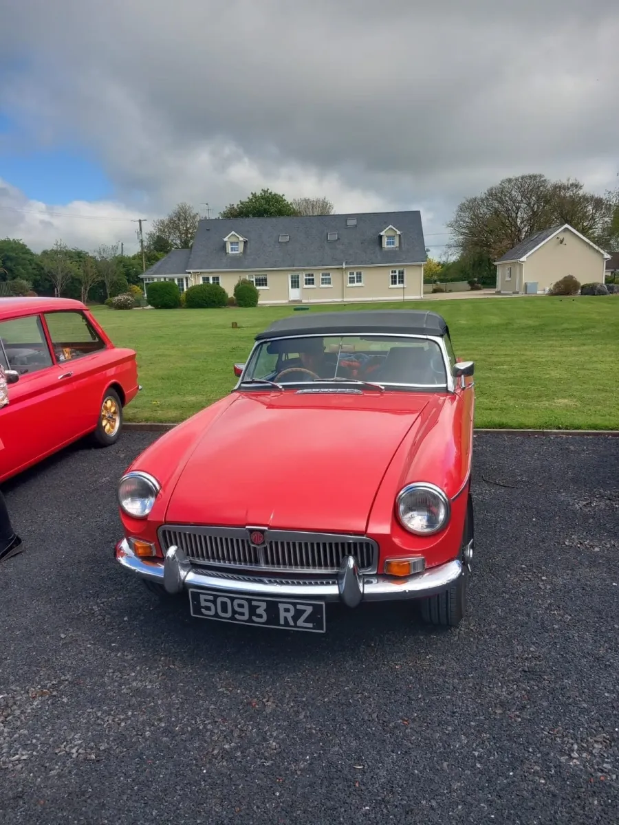 Red vintage car parked on a driveway