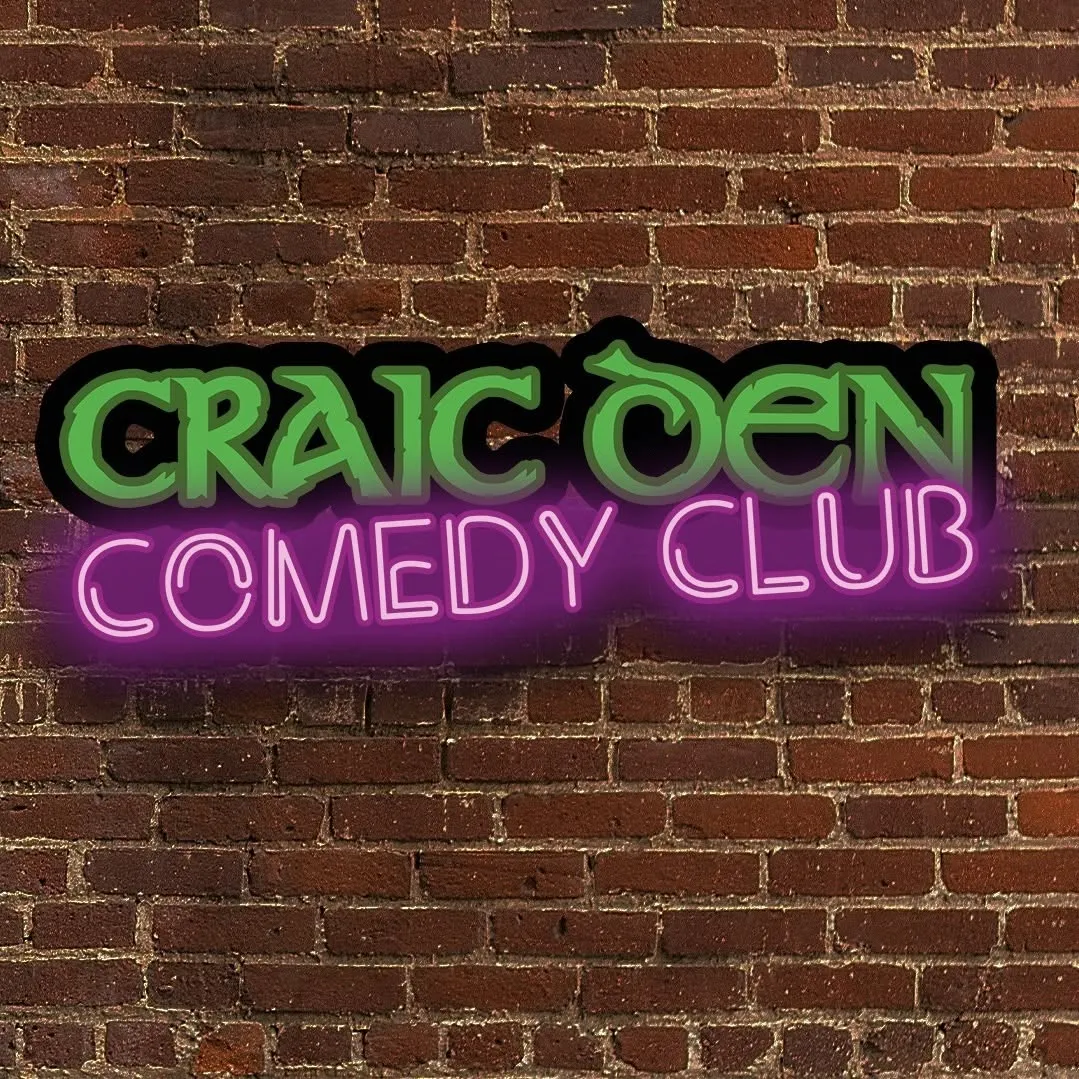 Craic Den Comedy Club neon sign on brick wall