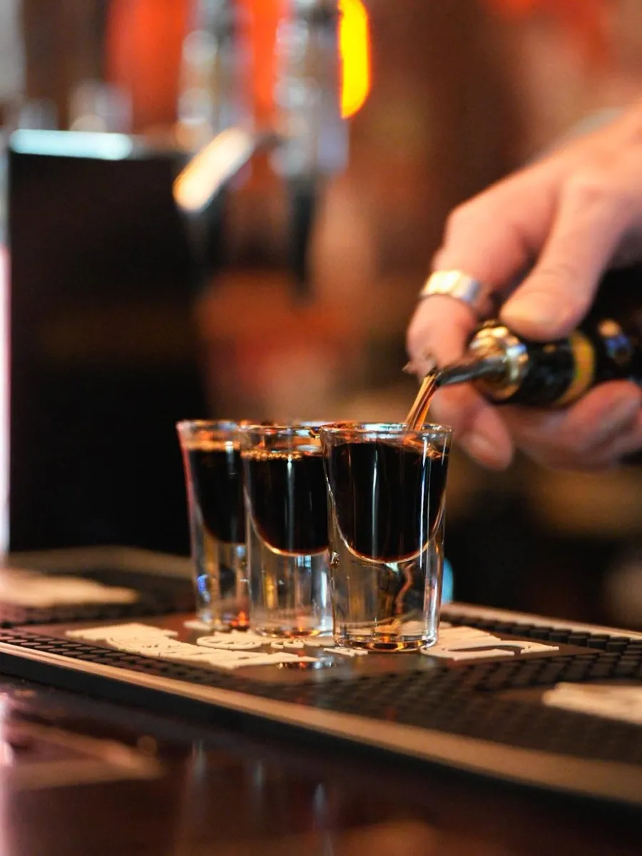Bartender pouring shots at a bar