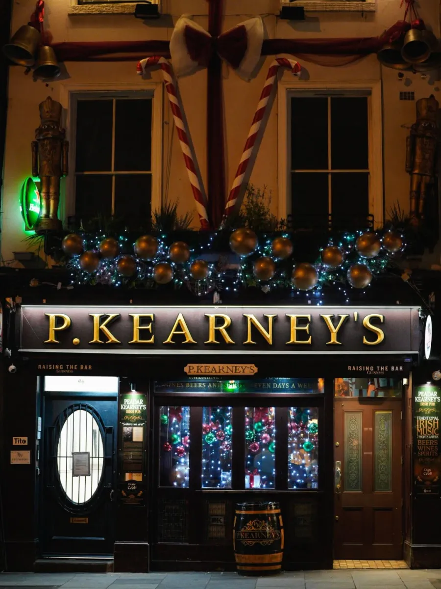 Festively decorated pub entrance at night
