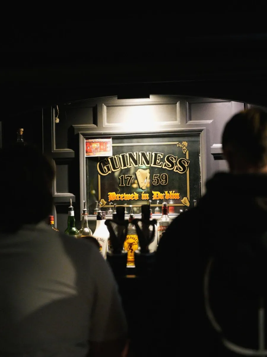 Bar counter with Guinness sign and bottles