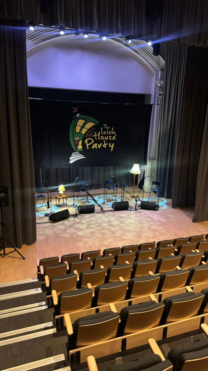 Empty theater stage set for Irish House Party.