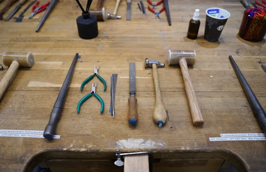 Wooden workbench with various hand tools.