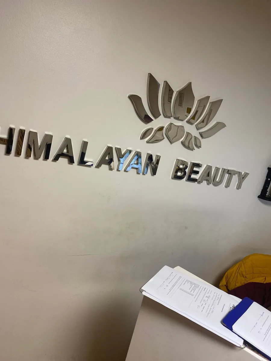 Wall with 'Himalayan Beauty' sign and a lotus design.