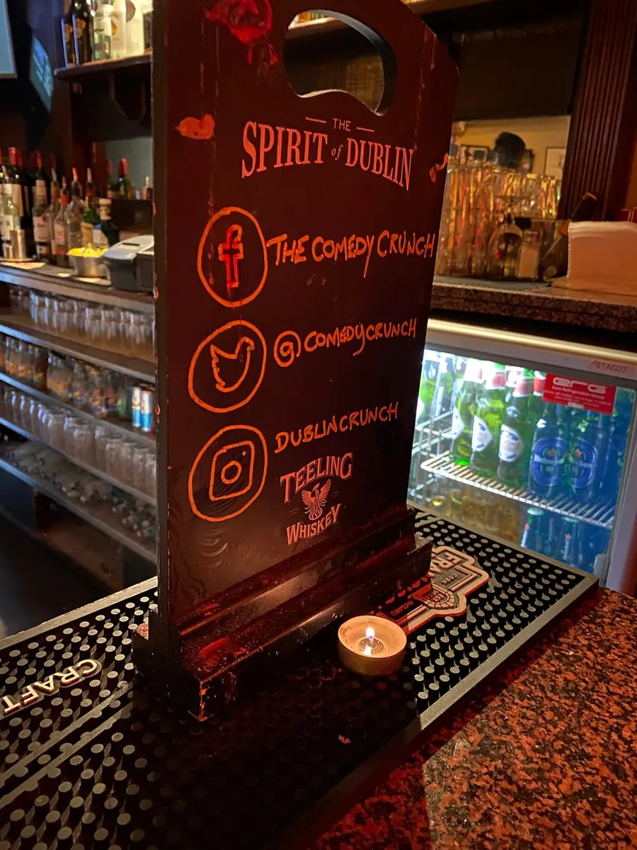 Bar counter with social media sign and candle.