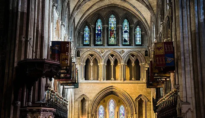 Interior of a gothic cathedral with stained glass windows.