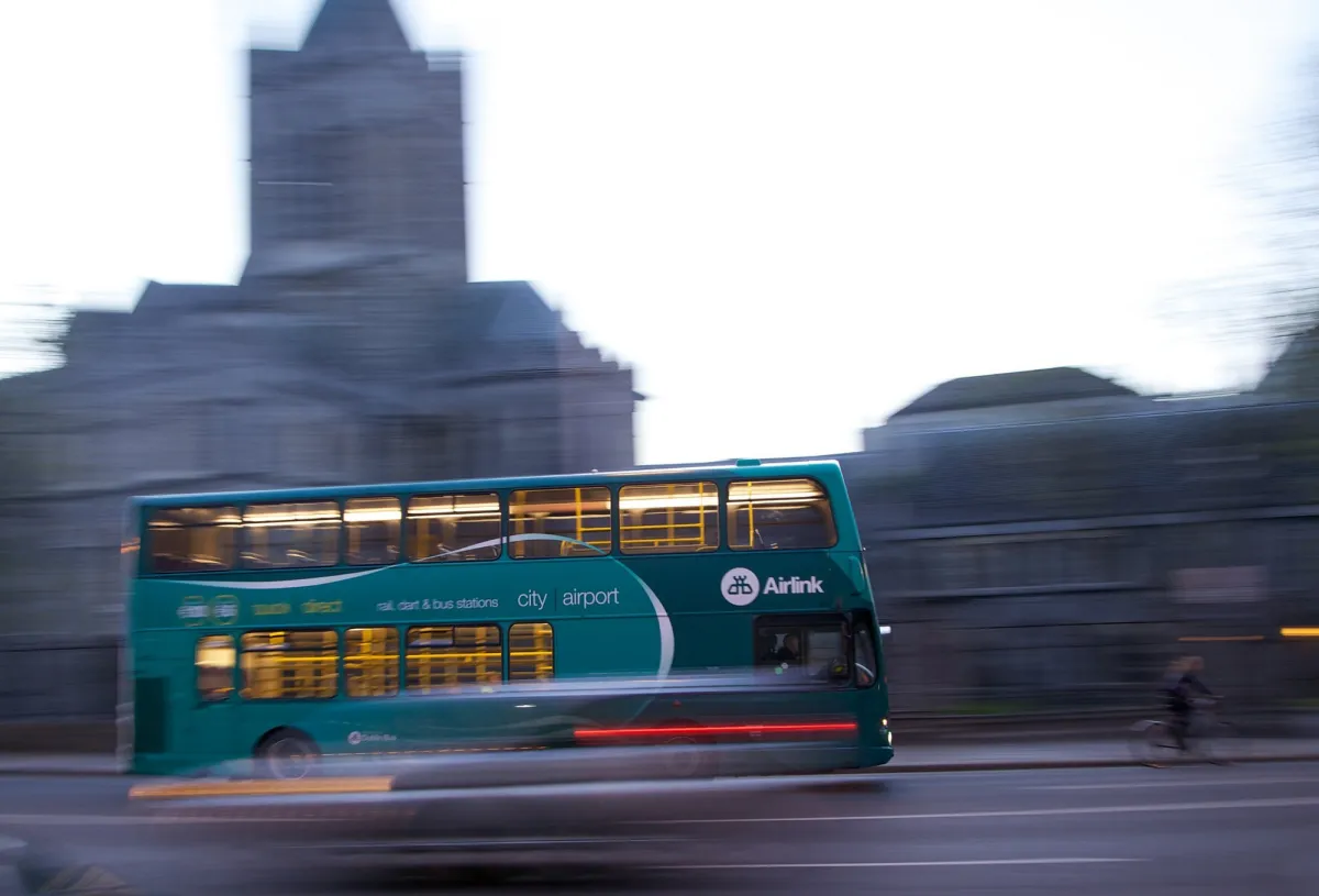 Moving double-decker bus on city street