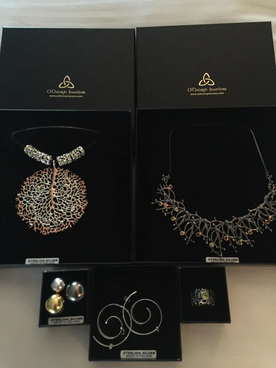 Collection of sterling silver jewelry in black boxes.