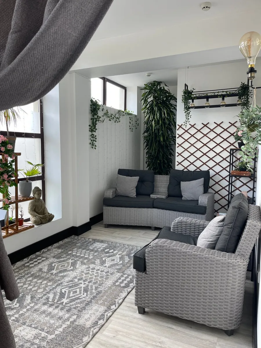 Modern living room with gray sofas and plants.