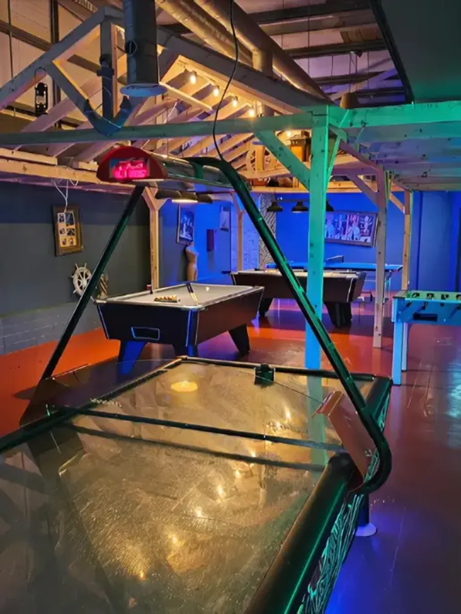 Game room with air hockey and pool tables