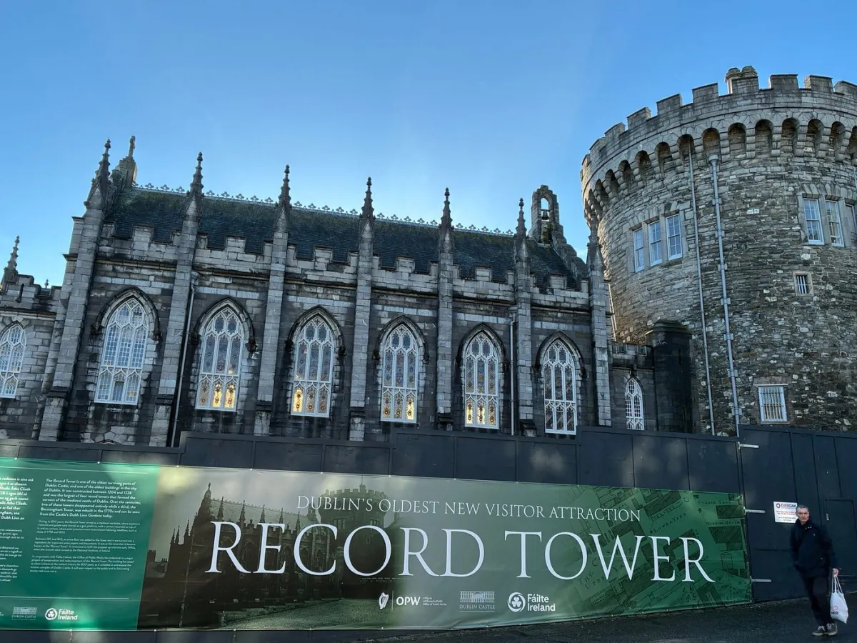 Historic stone building with gothic windows and a tower.