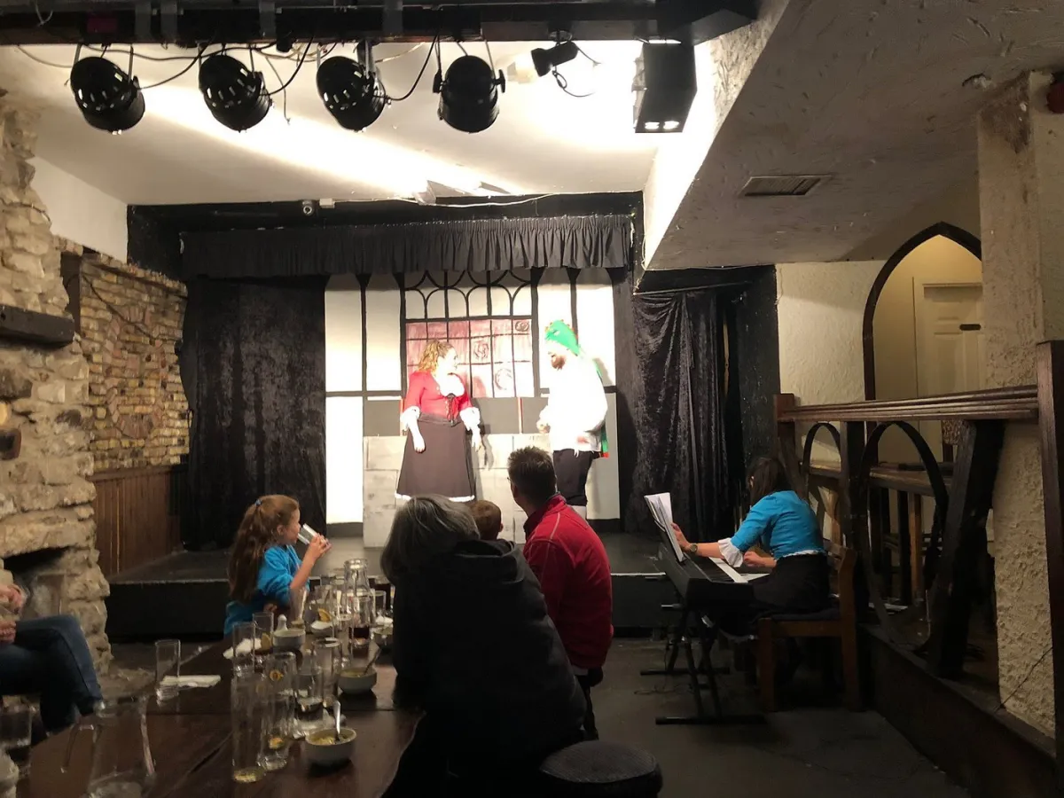 Small theater performance with audience and pianist