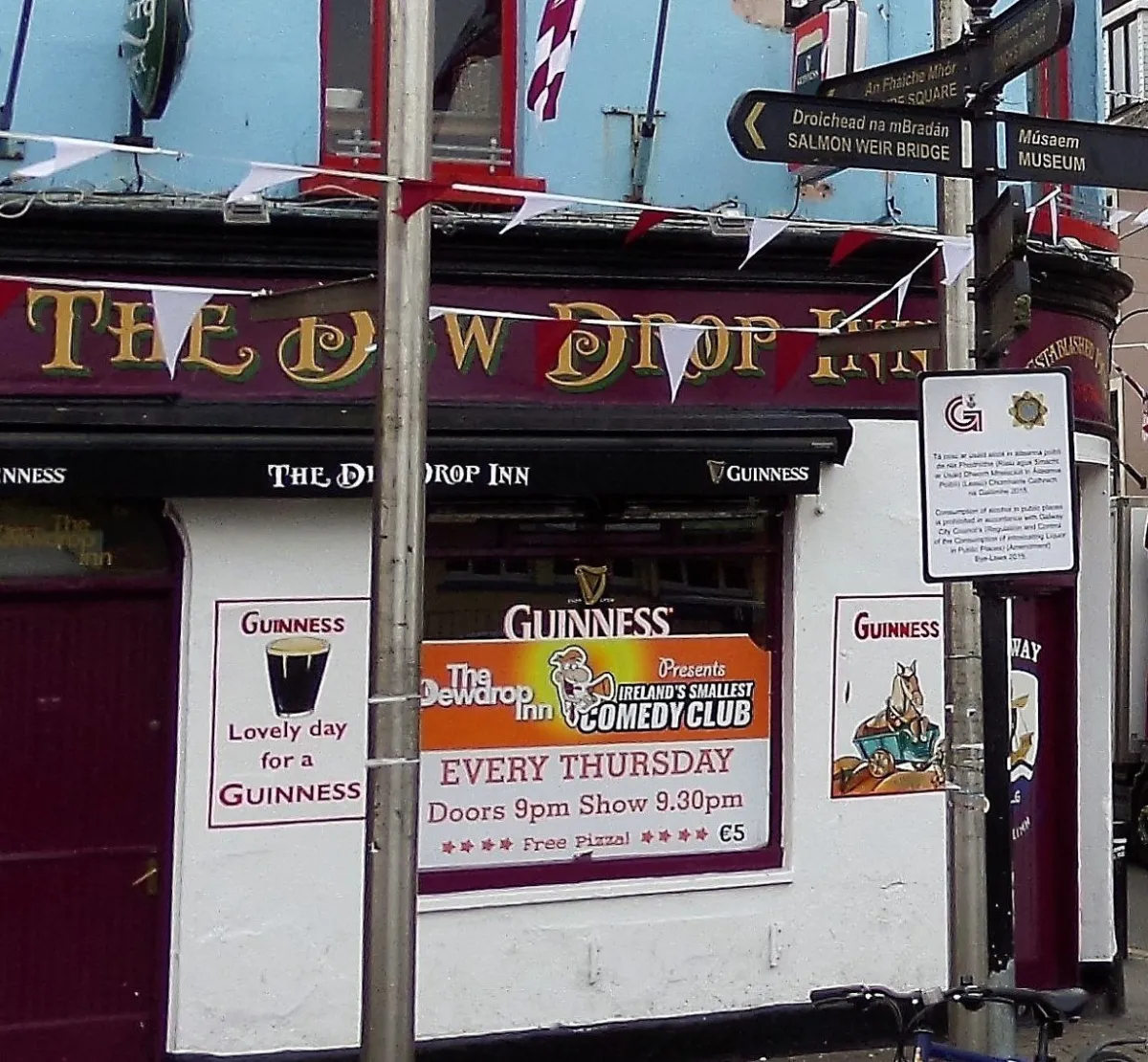 Exterior of The Dew Drop Inn with comedy club sign.