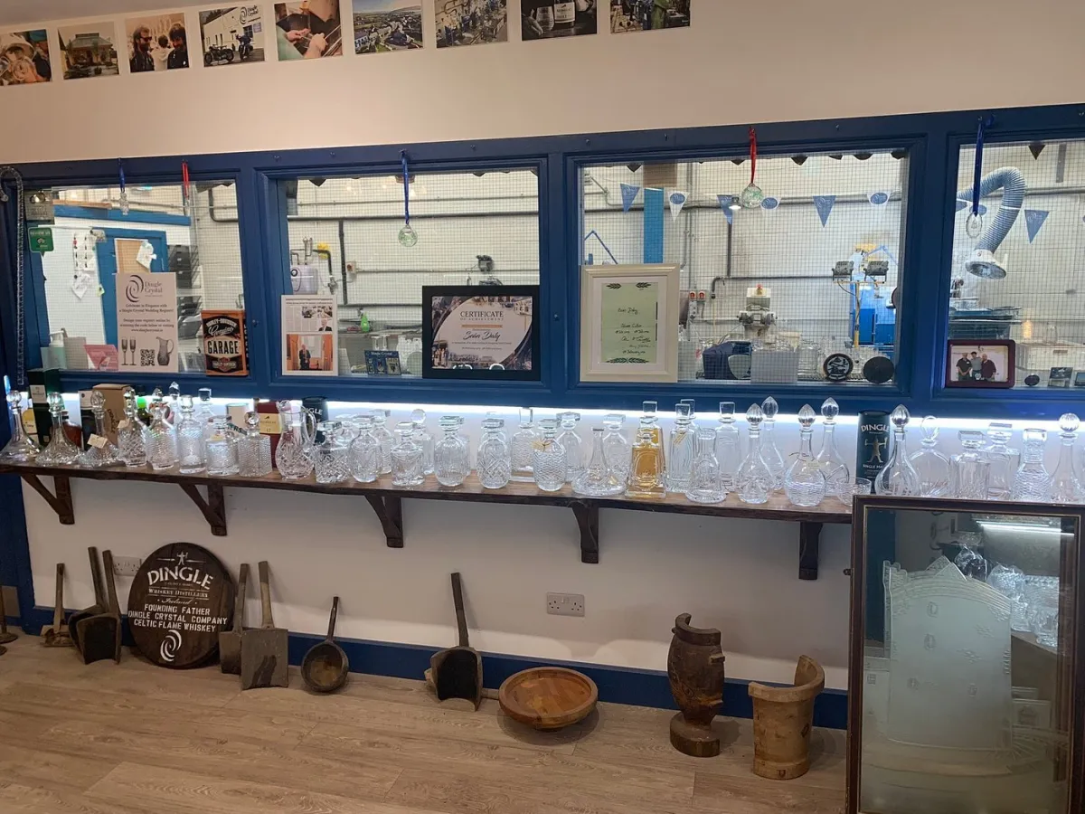Display of crystal decanters and certificates in a workshop.