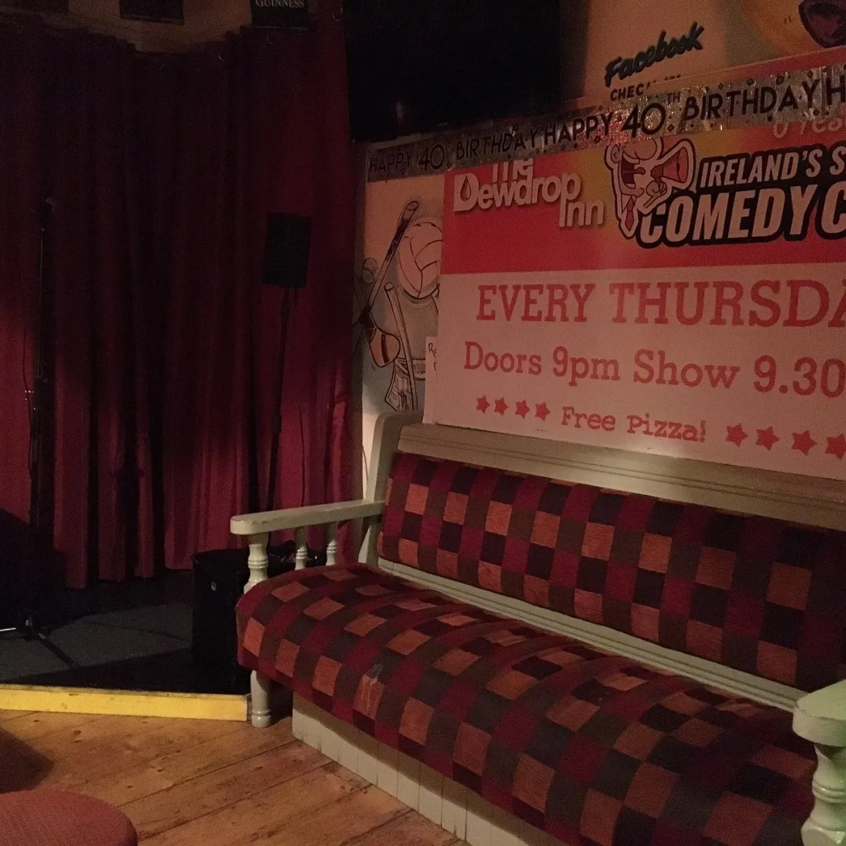 Empty stage with microphone and comedy show poster