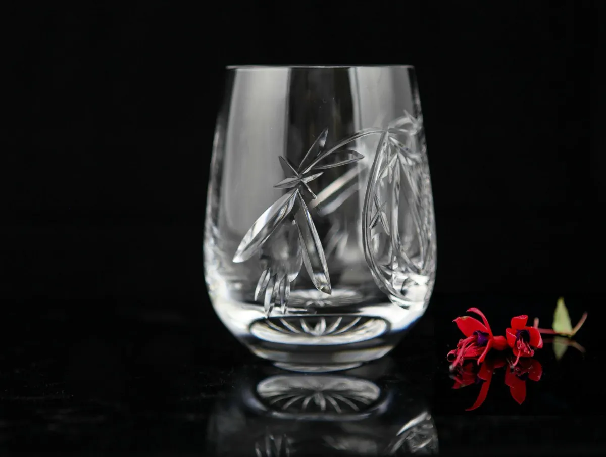 Crystal glass with floral engravings and red flowers