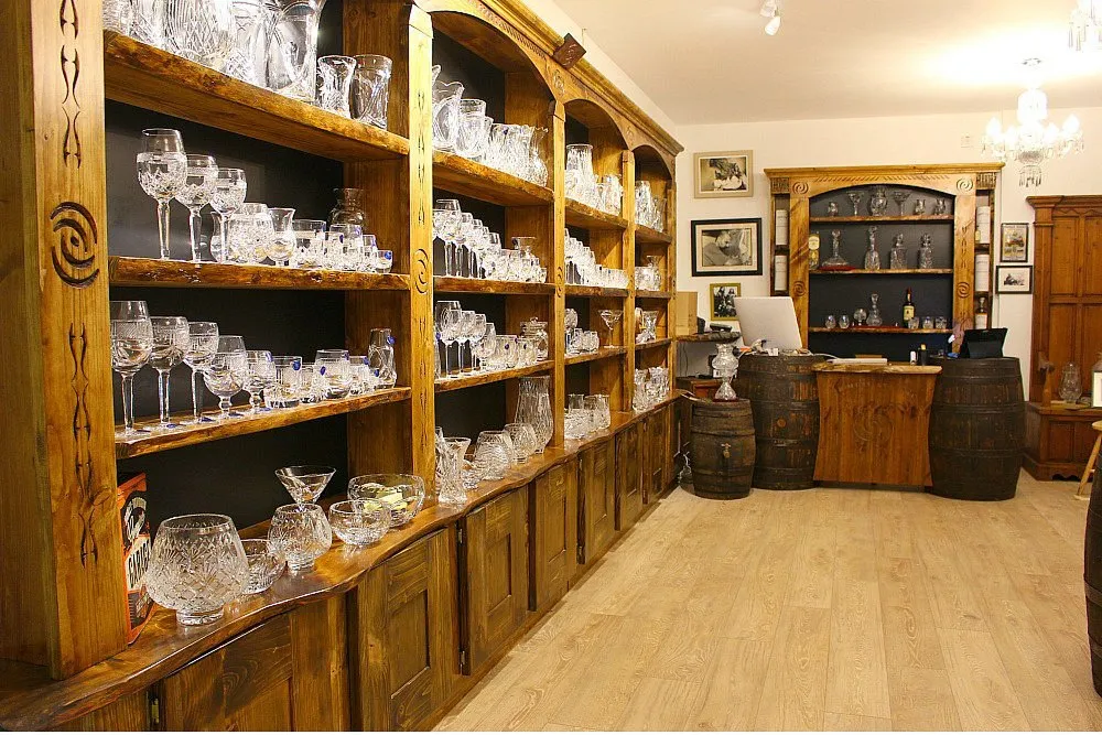Wooden shelves with crystal glassware in a shop.