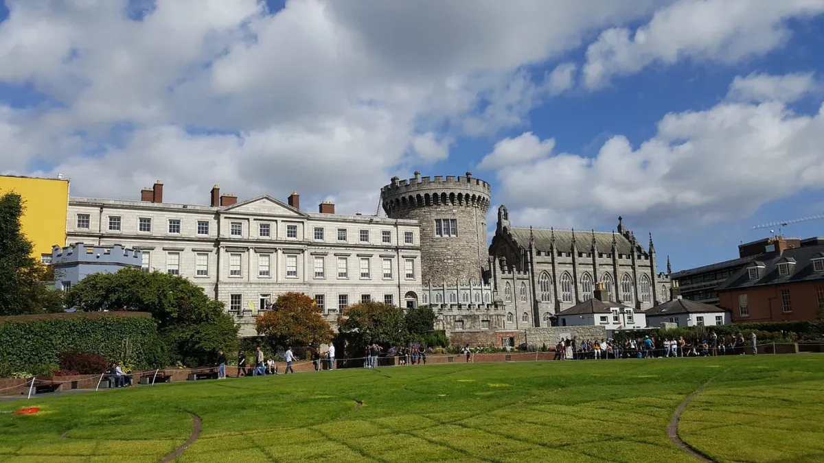 Historic castle with garden under a blue sky
