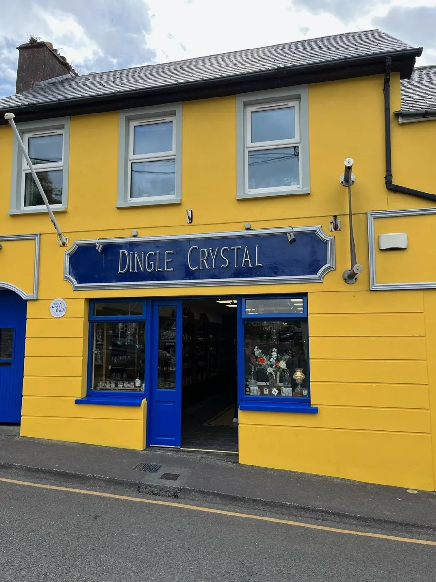 Yellow building with a sign reading 'Dingle Crystal'.