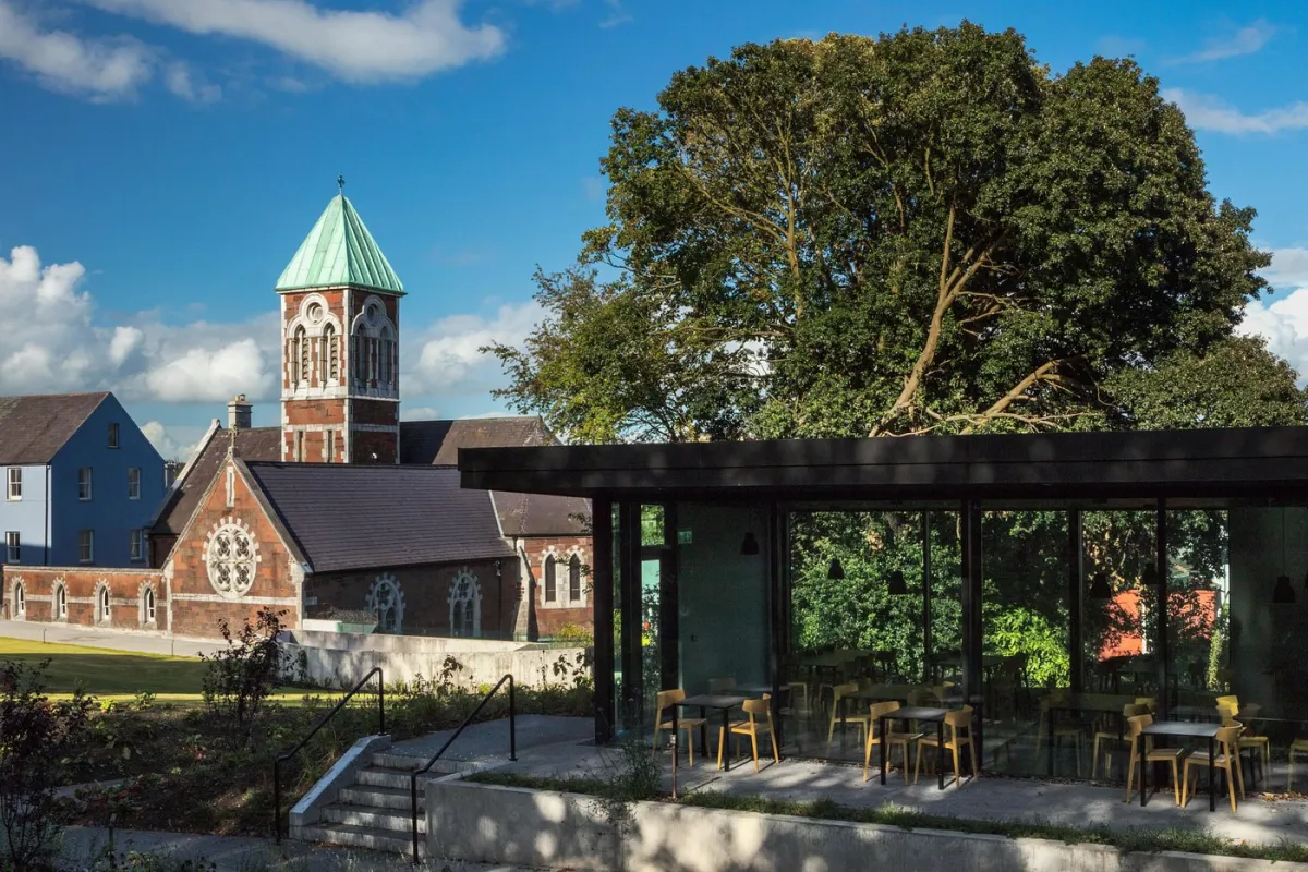 Church with clock tower and modern glass building.
