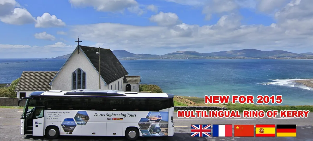Tour bus parked by a church with ocean view.
